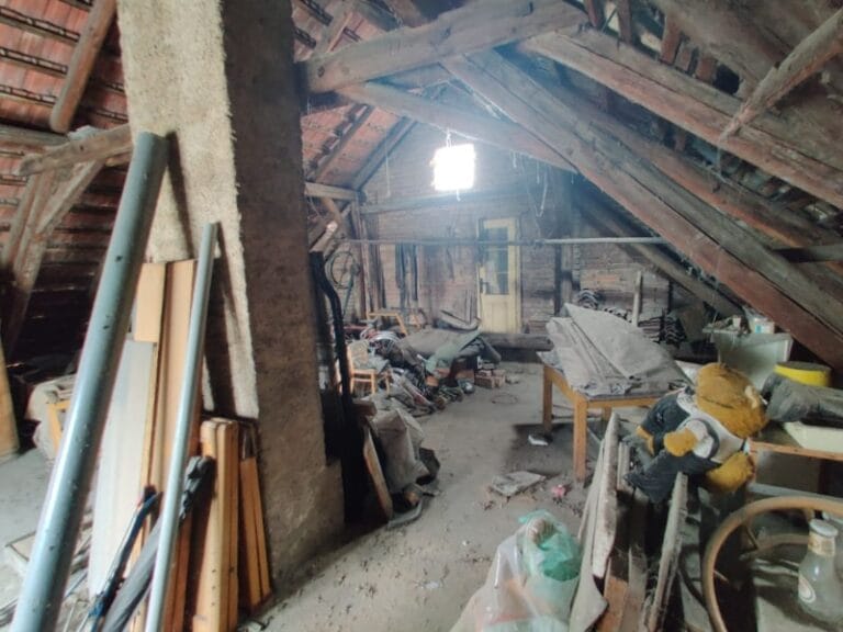 Zanedbaná půda s nepořádkem, připravená k vyklízení a úklidu.